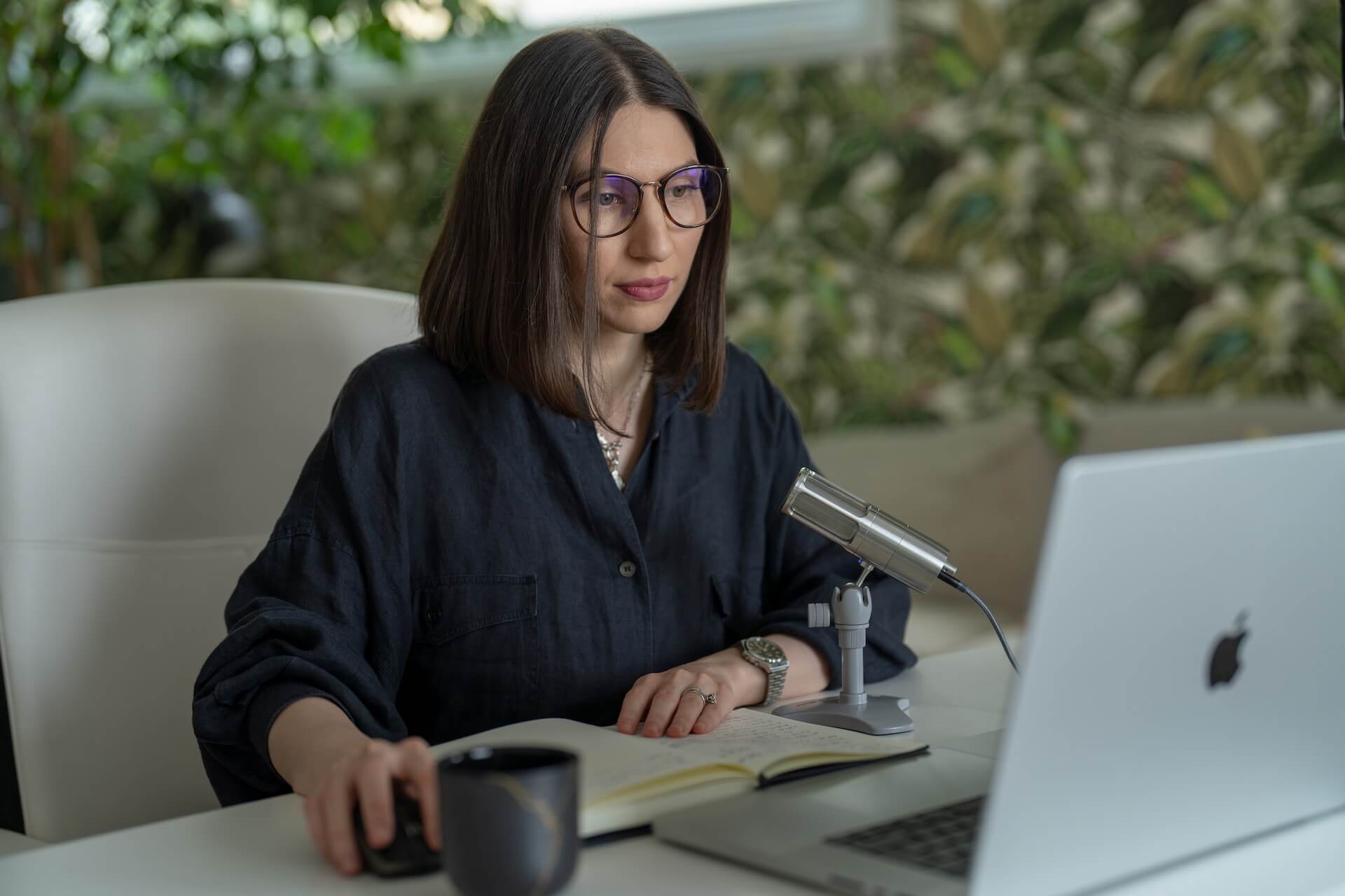 Female streaming from her office using a microphone for her Zoom Meeting